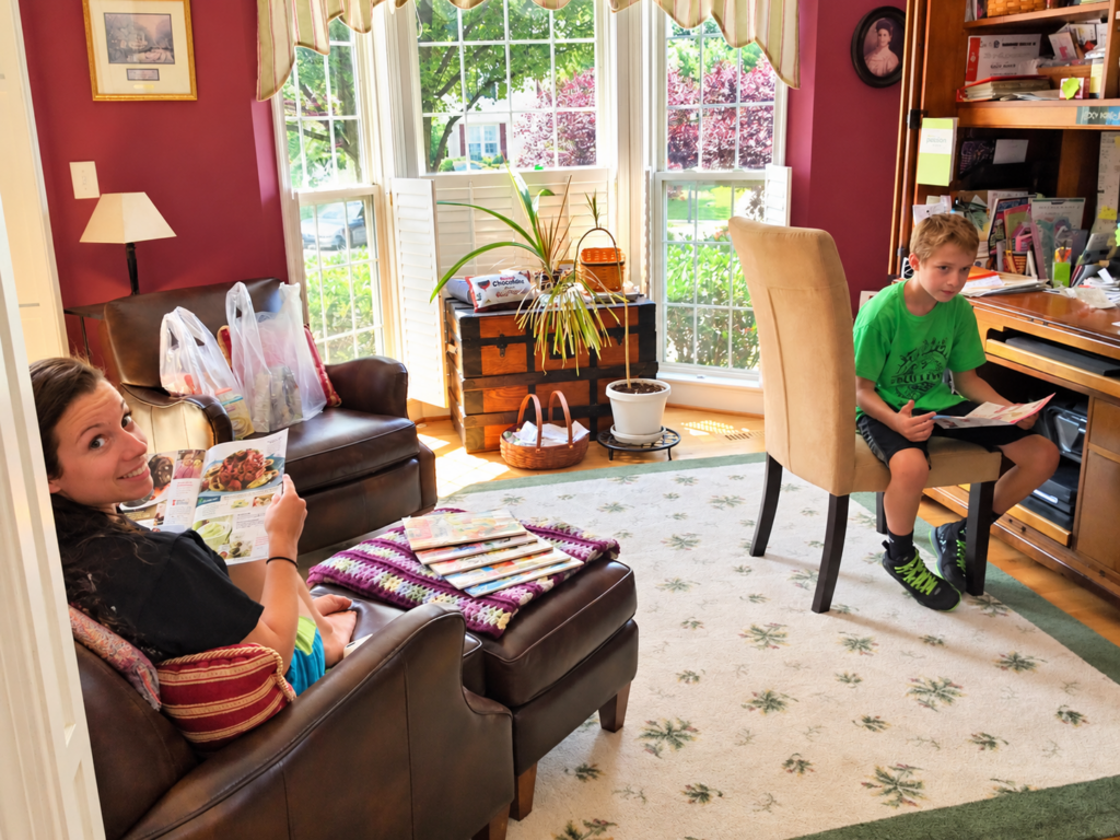 Vicky's kids looking through Tastefully Simple materials at home in 2014.